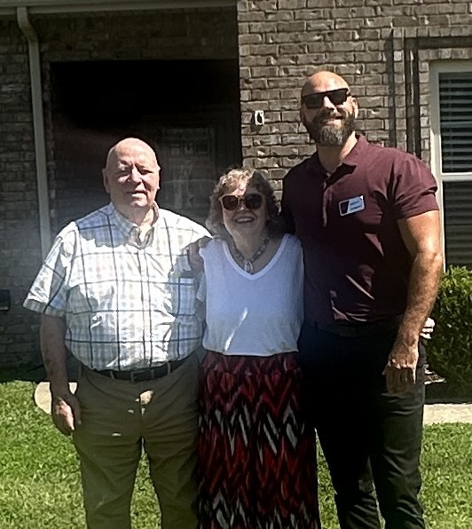 Mack and Susie Farmer with Dan Previti at listing